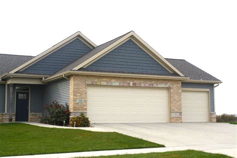 tan brick house with blue trim and metal roof|blue brick exterior designs.